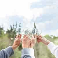 Free photo concept people holding glass bulbs in air