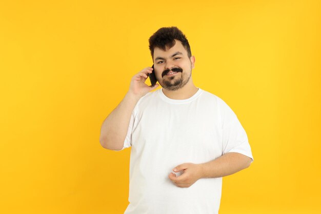 Concept of people young fat man on yellow background