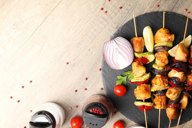 Concept of tasty food with chicken shashlik on light wooden background Free Photo