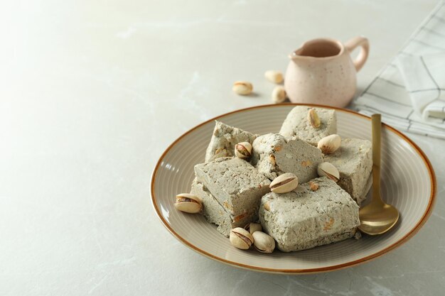 Concept of tasty food with halva on light background