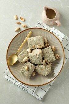 Concept of tasty food with halva on light background