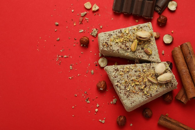 Concept of tasty food with halva on red background Premium Photo