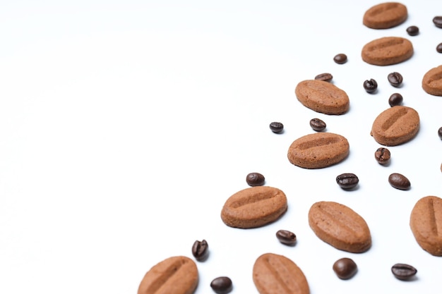 Concept of tasty snack for hot drink cookies in the shape of coffee seeds