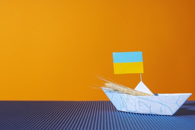 Concept of Ukrainian grain export with paper boat