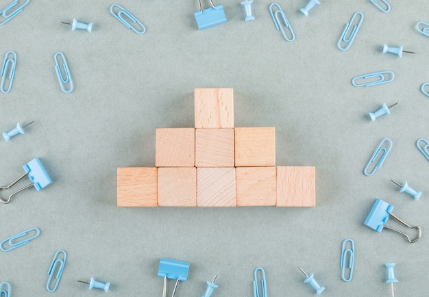 Free photo conceptual of business with wooden blocks, paperclips, binder clips.