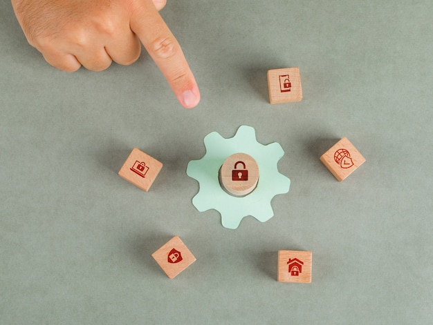 Free photo conceptual of data privacy man hand pointing. with wooden blocks, paper settings icon.