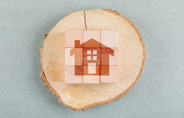 Conceptual of real estate with wooden blocks, wooden human figure top view.