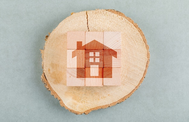 Conceptual of real estate with wooden blocks, wooden human figure top view.