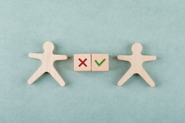 Conceptual of search employee with wooden blocks with true false icons, wooden human figure top view.