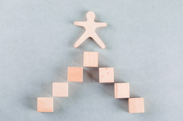 Free photo conceptual of success business with wooden human, rectangle blocks.