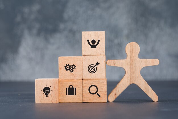 Conceptual of success and target. with wooden human and blocks.