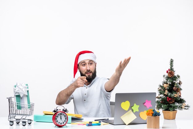 Concerned young businessman in office celebrating new year or christmas working alone