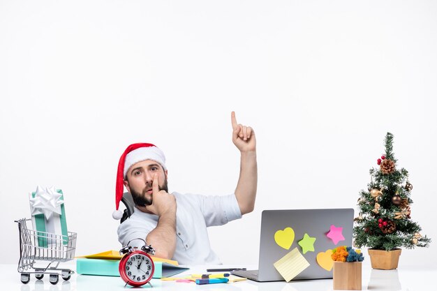 Concerned young businessman with santa claus hat working at new year