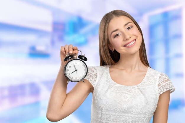 Concerned young woman with clock