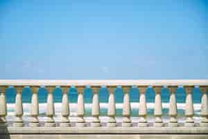 Free photo concrete pillar fence and blue sky