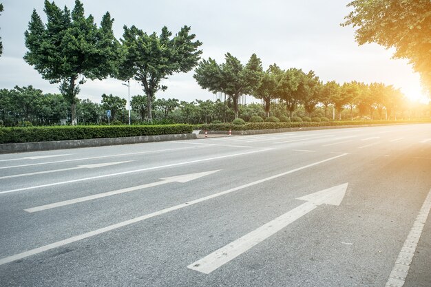 Concrete road with arrows at sunrise