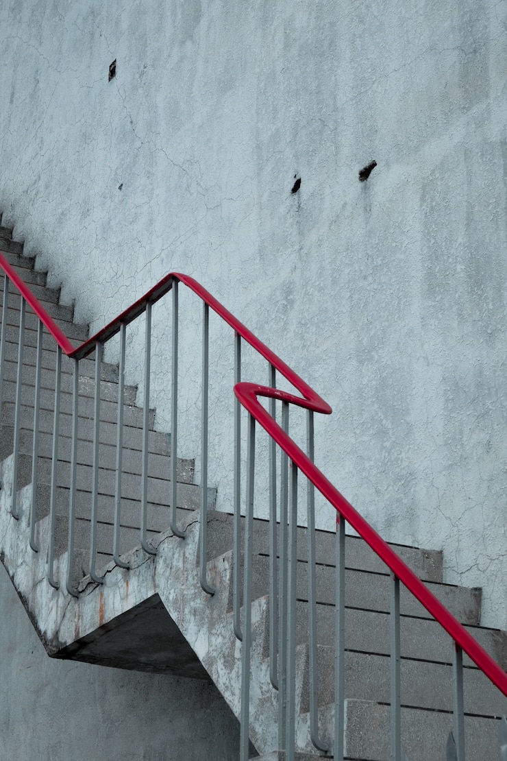 Free Photo concrete stairs with a red handrail