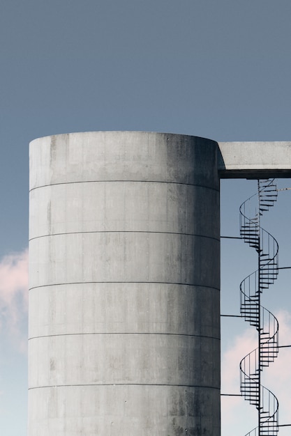 concrete structure with metal stairway under the blue sky