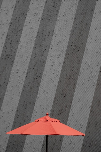 Free photo concrete wall of a building with a red umbrella