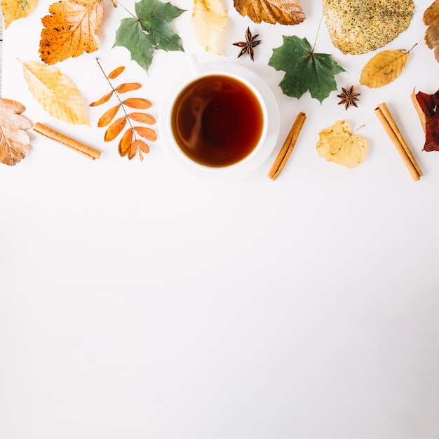 Condiment and leaves with cup in arrangement