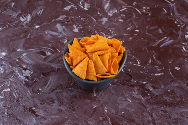 Cone chips in a bowl , on the marble table. 