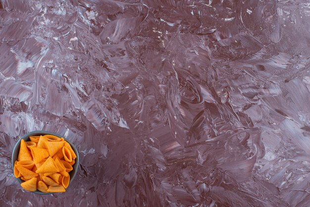 Cone chips in a bowl on marble. 