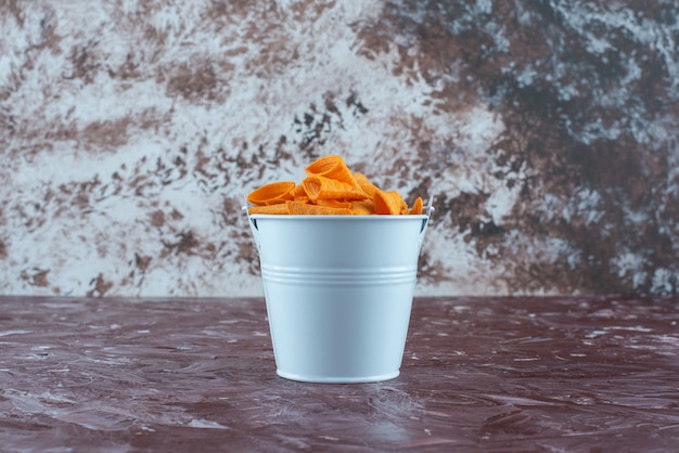 Free photo cone chips in a bucket , on the marble table.