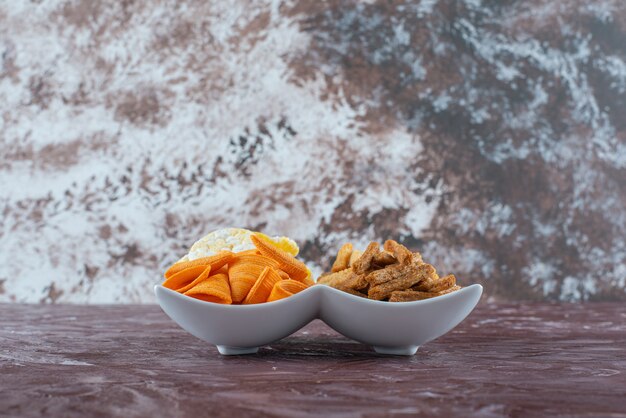 Cone chips with breadcrumbs in a bowl , on the marble table. 