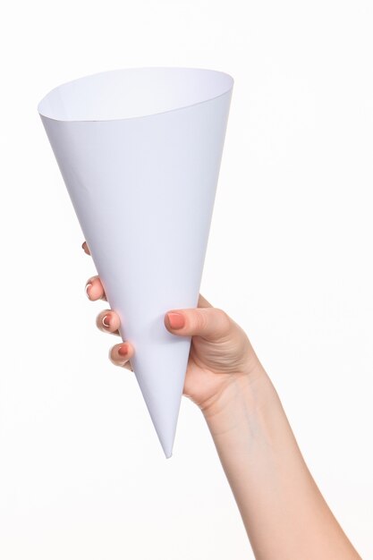 The cone in female hands on white space