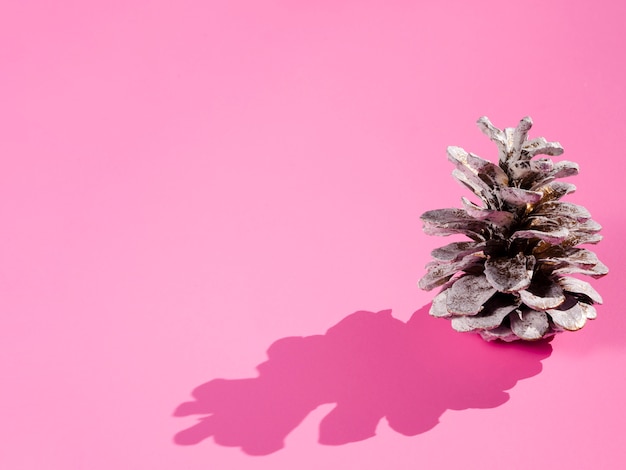 Free photo cone with shadow on pink background