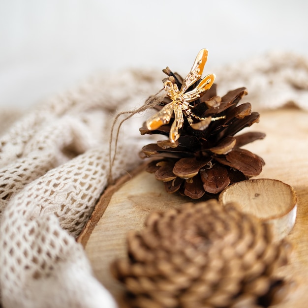 Free photo cones on a wooden stump surrounded by white lace textiles