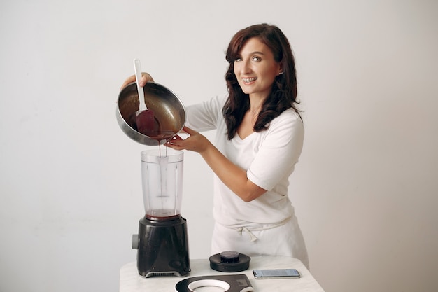 Confectioner mixes the ingredients. Lady is preparing dessert.Woman bakes a cake.