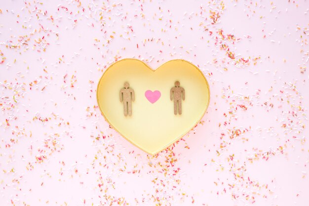 Confetti around heart with gay couple