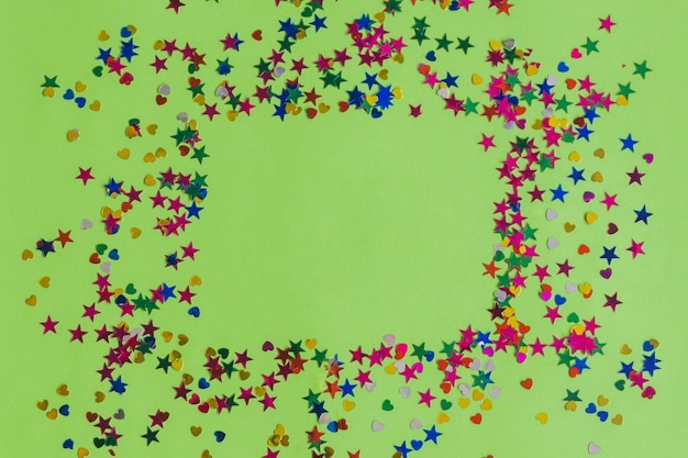 Confetti on a green table making a square