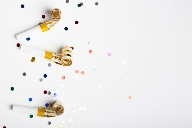 Confetti and party whistles with copy space