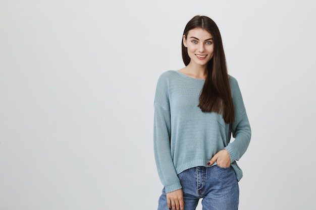 Confident attractive woman smiling, hold hand in pocket
