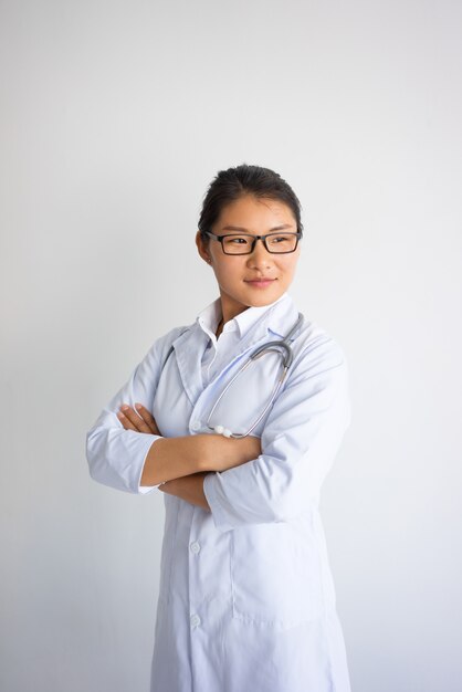 Confident attractive young Asian female doctor. 