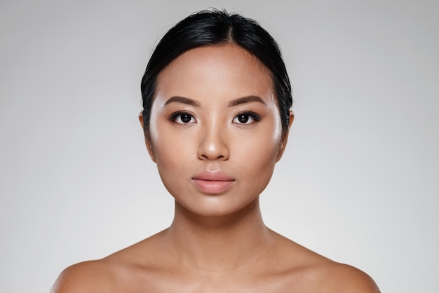 Confident beautiful lady looking camera isolated over grey