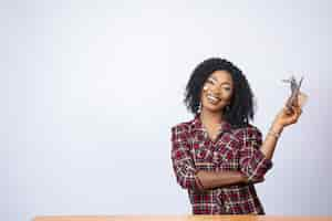 Free photo confident black lady sitting and showing off a wad of cash