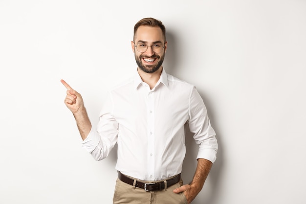 Confident businessman pointing finger left