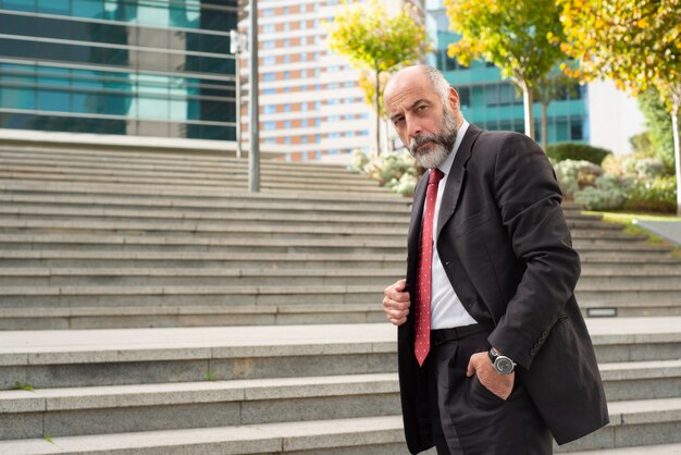 Confident businessman standing on street