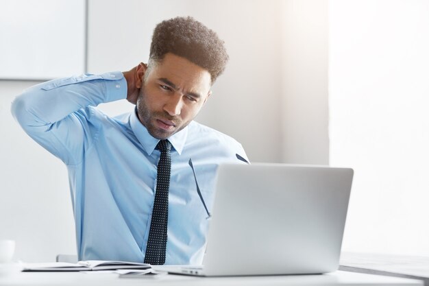 Confident businessman working on his laptop