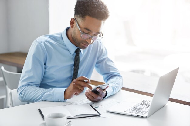 Confident businessman working on his laptop