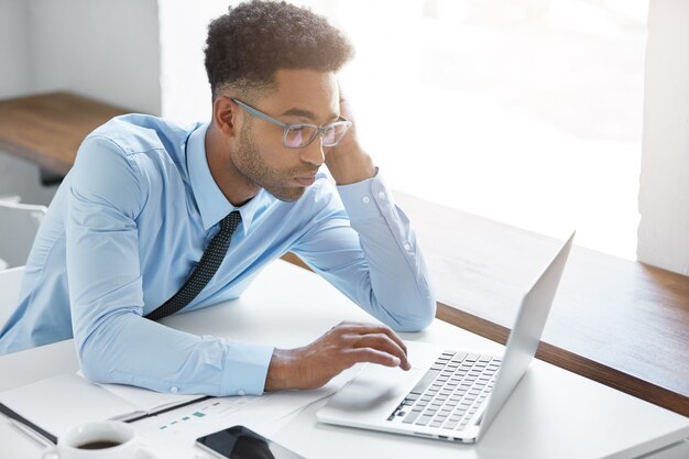 Confident businessman working on his laptop