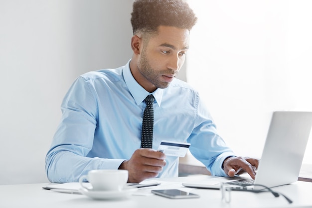 Confident businessman working on his laptop