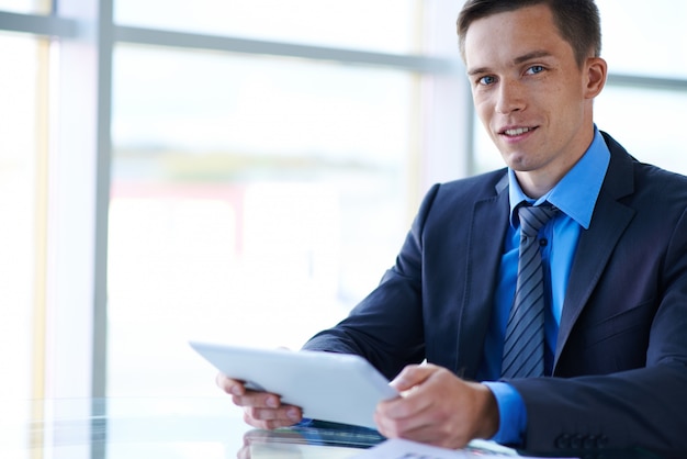 Confident businessman working with a tablet