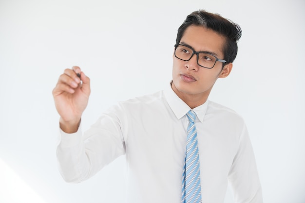 Confident businessman writing with highlighter