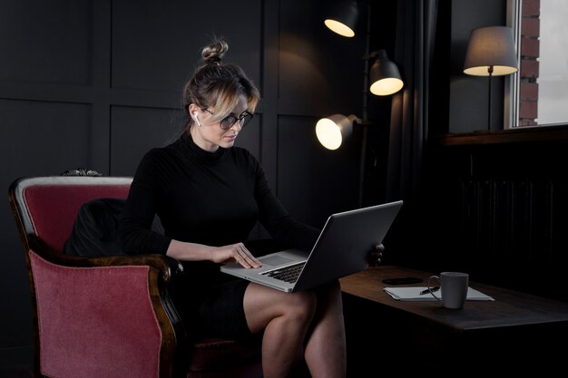 Confident businesswoman working on her laptop