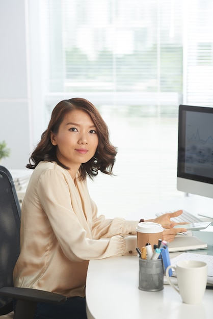 Confident businesswoman at workplace