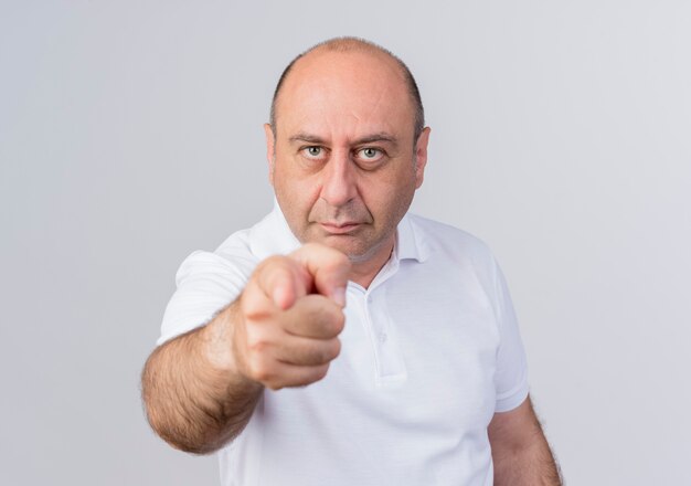 Confident casual mature businessman looking and pointing at camera isolated on white background